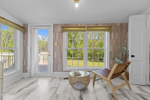 sunroom / solarium with visible vents, marble finish floor, and baseboards