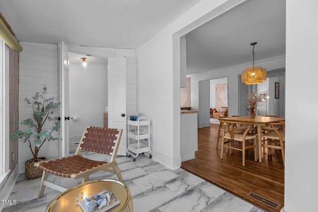 living area featuring visible vents and marble finish floor
