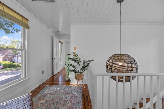 hall featuring wood ceiling, a wealth of natural light, ornamental molding, and wood finished floors