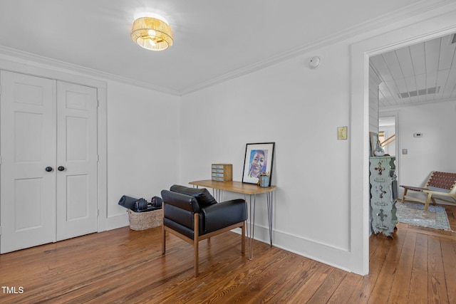 interior space with hardwood / wood-style flooring, baseboards, and ornamental molding