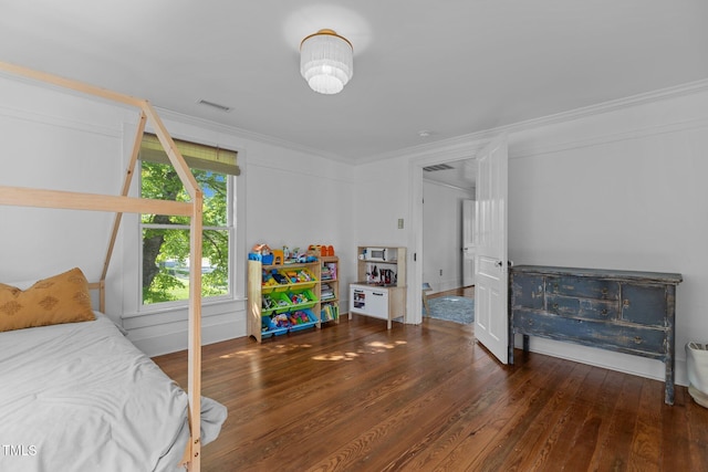 bedroom featuring visible vents, crown molding, and hardwood / wood-style flooring