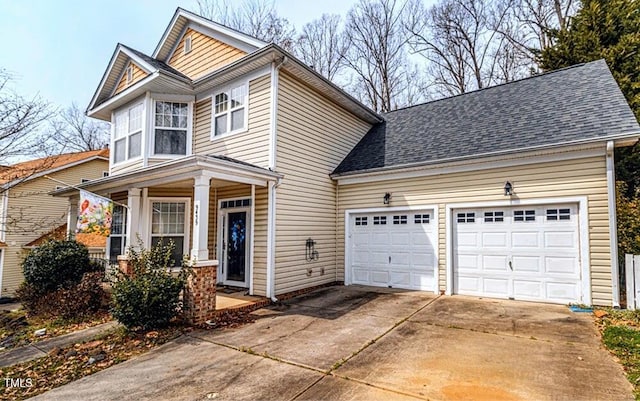view of front of property featuring a porch, a shingled roof, a garage, and driveway