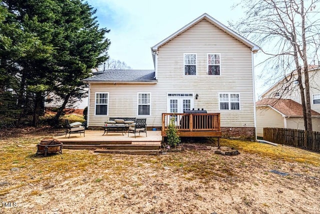 rear view of house featuring an outdoor living space with a fire pit, fence, a deck, and roof with shingles