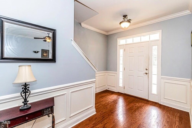 entryway featuring wood-type flooring, wainscoting, and ornamental molding