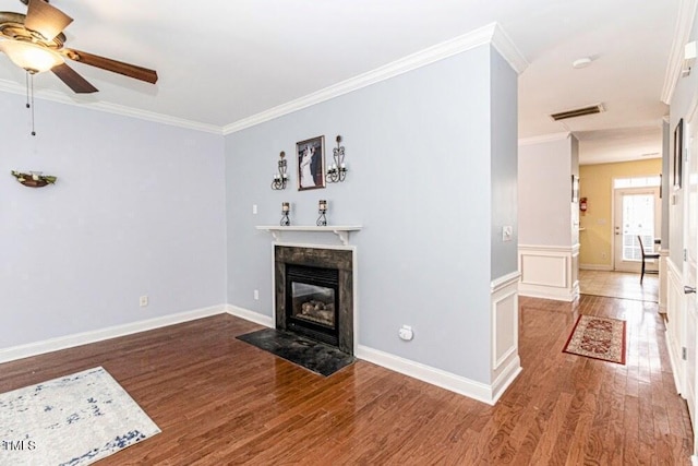 unfurnished living room with crown molding, visible vents, ceiling fan, and wood finished floors