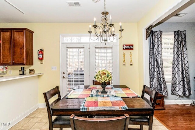 dining area featuring visible vents, baseboards, and an inviting chandelier
