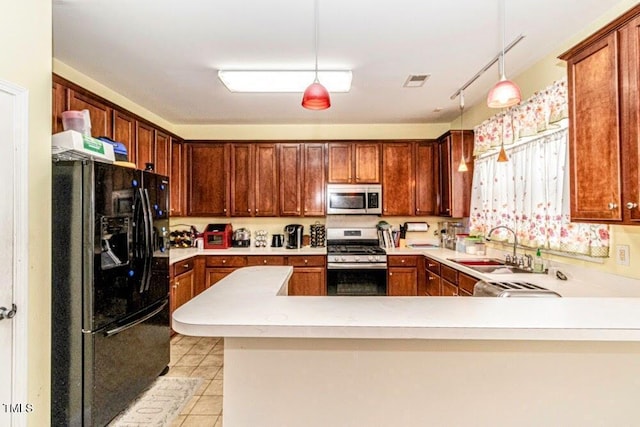 kitchen featuring light tile patterned floors, light countertops, visible vents, stainless steel appliances, and a sink