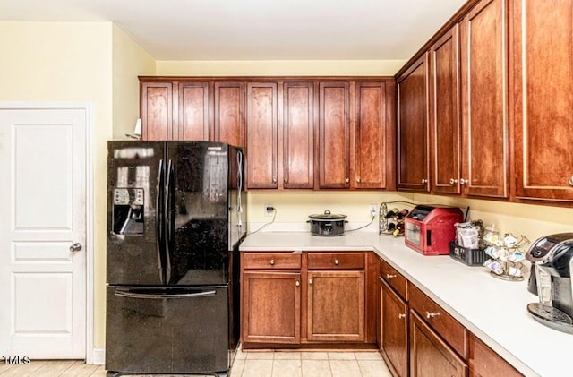 kitchen with black fridge and light countertops