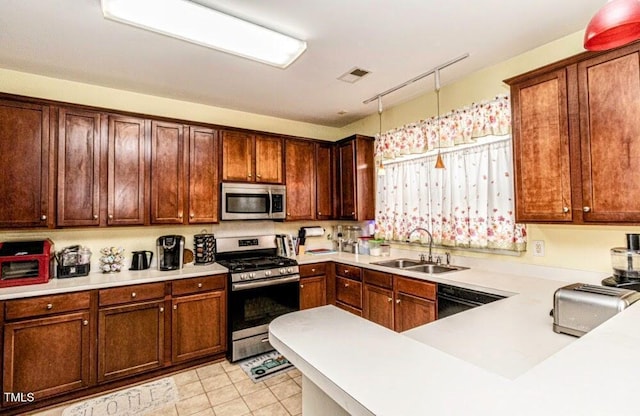 kitchen with a sink, light countertops, light tile patterned flooring, and stainless steel appliances