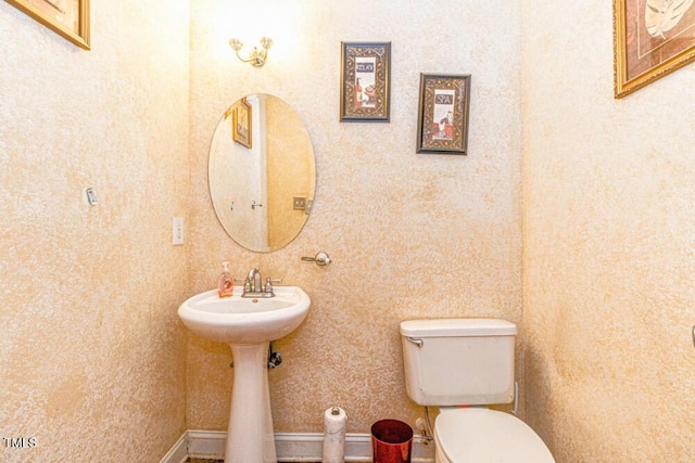 half bathroom featuring toilet