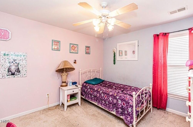 bedroom featuring ceiling fan, light colored carpet, baseboards, and visible vents