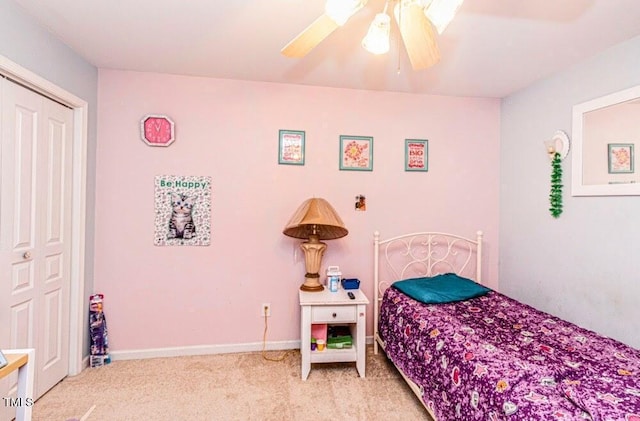 bedroom featuring light carpet, baseboards, and a ceiling fan