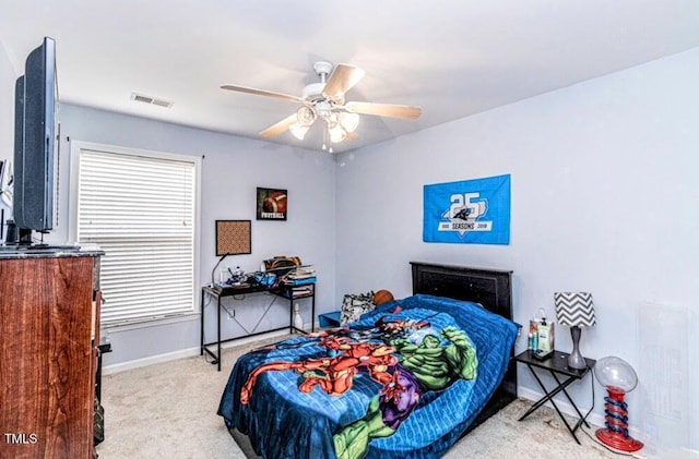 carpeted bedroom with visible vents, baseboards, and ceiling fan