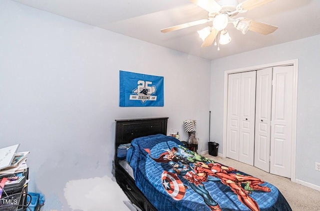 carpeted bedroom with baseboards, a closet, and a ceiling fan