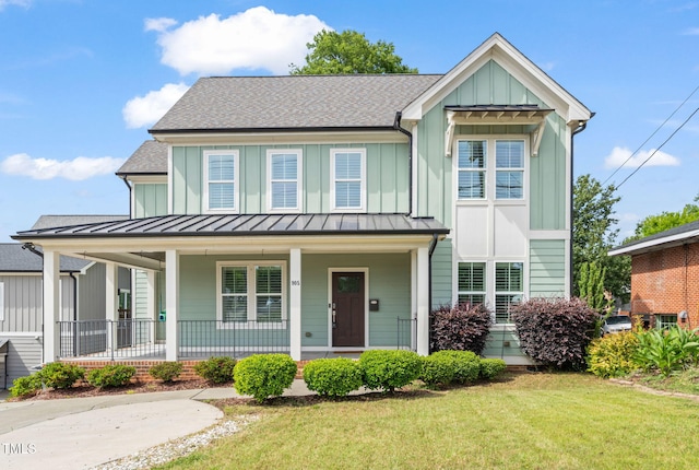905 E Lenoir St, Raleigh, NC 27610 - view of front of property featuring a standing seam roof, covered porch, board and batten siding, and a front lawn
