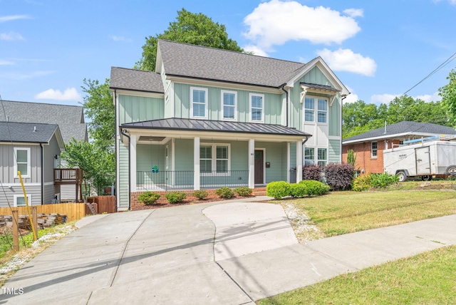 905 E Lenoir St, Raleigh, NC 27610 - traditional home with a standing seam roof, covered porch, board and batten siding, metal roof, and a shingled roof