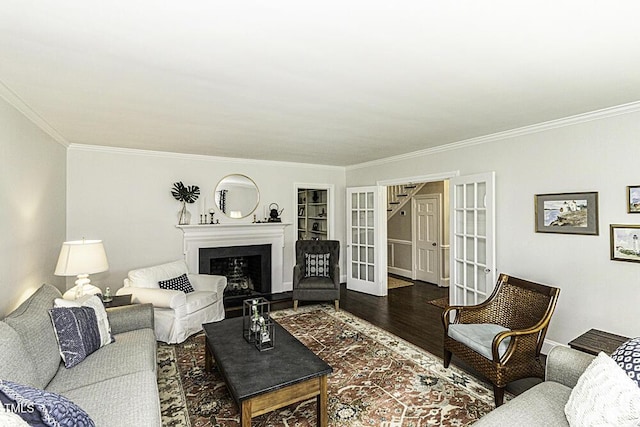 living room featuring french doors, crown molding, and wood finished floors
