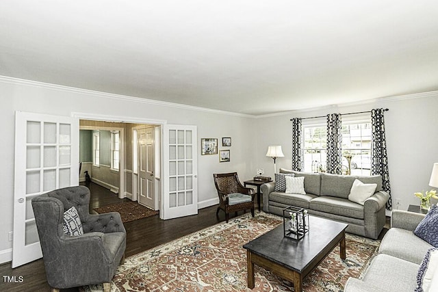 living area with baseboards, ornamental molding, and wood finished floors