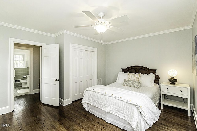 bedroom with crown molding, wood finished floors, and a closet