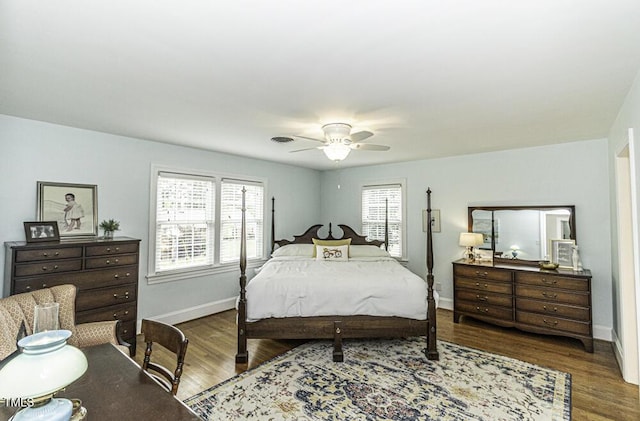 bedroom featuring visible vents, baseboards, a ceiling fan, and wood finished floors