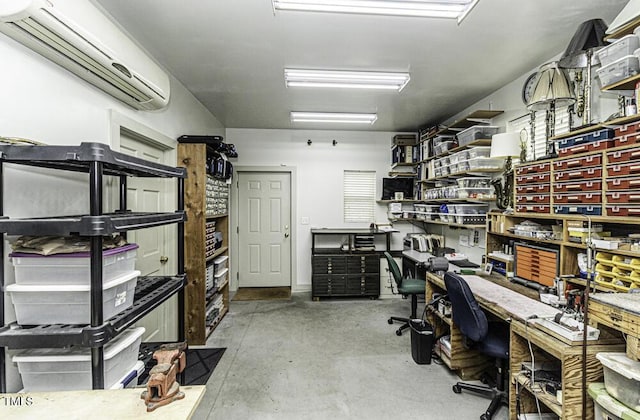 home office featuring a wall mounted AC and concrete floors