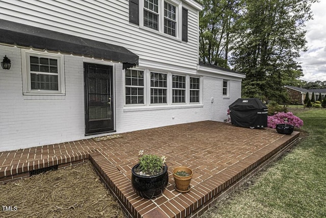 exterior space with a patio area and brick siding