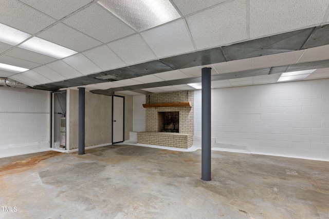 finished below grade area with concrete block wall and a fireplace