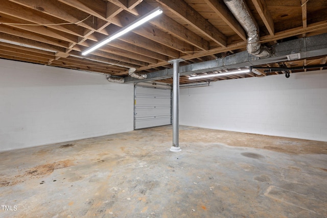 unfinished basement featuring concrete block wall