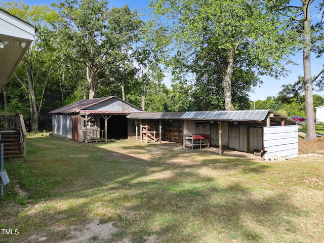 exterior space with an outbuilding, an exterior structure, and metal roof