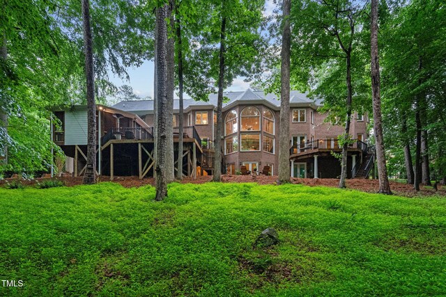 rear view of house featuring stairway and a wooden deck