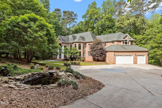 view of front facade featuring brick siding and driveway