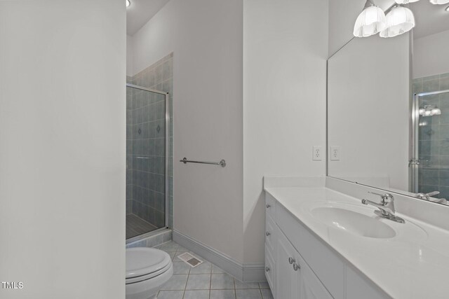 bathroom with tile patterned floors, a shower stall, and vanity