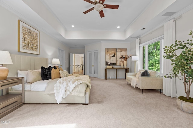 bedroom featuring crown molding, a raised ceiling, visible vents, recessed lighting, and light carpet