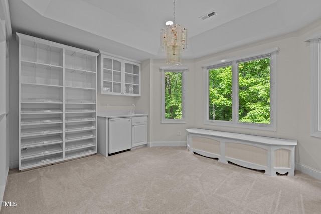 interior space featuring indoor wet bar, visible vents, radiator heating unit, baseboards, and light colored carpet