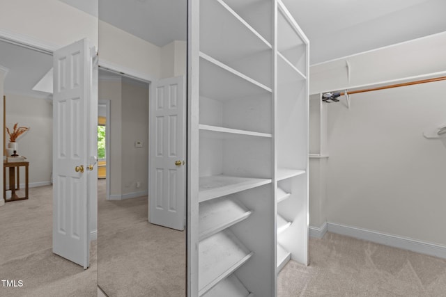 walk in closet with carpet flooring