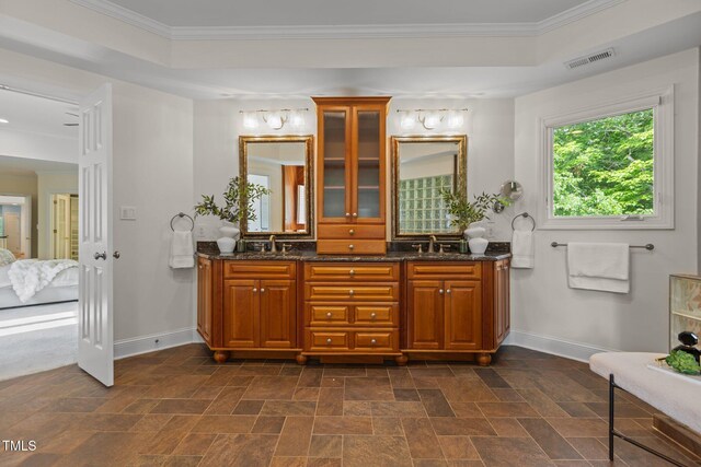 bathroom with crown molding, stone finish floor, connected bathroom, and baseboards