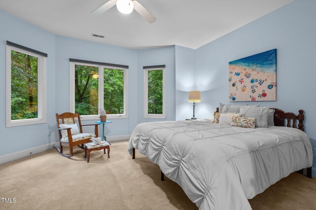bedroom featuring visible vents, multiple windows, carpet, and baseboards