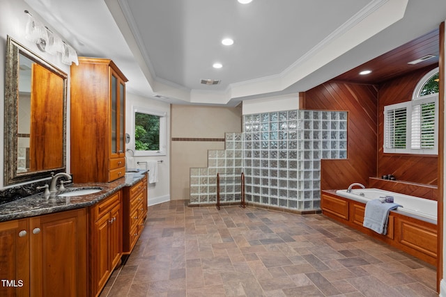 full bathroom featuring a bath, wooden walls, crown molding, visible vents, and stone finish floor