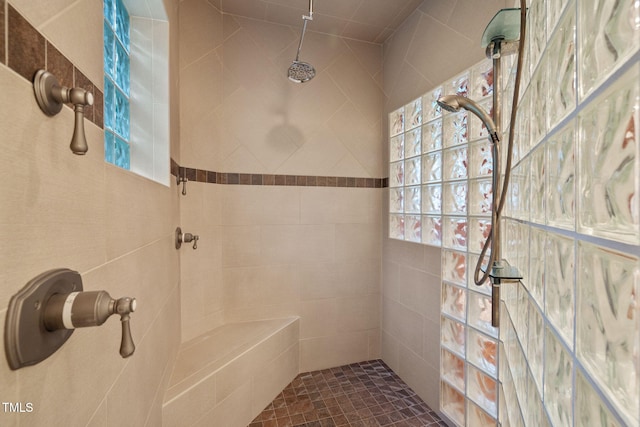bathroom with a tile shower