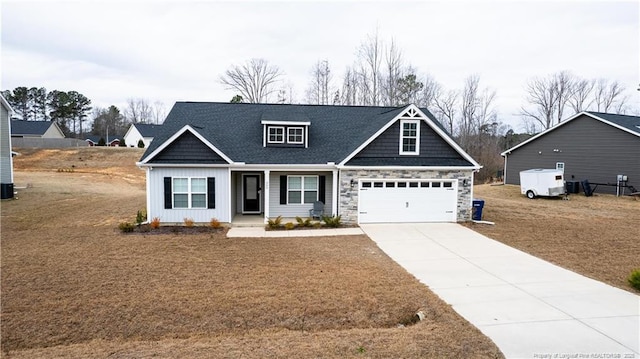 craftsman-style home with stone siding and driveway