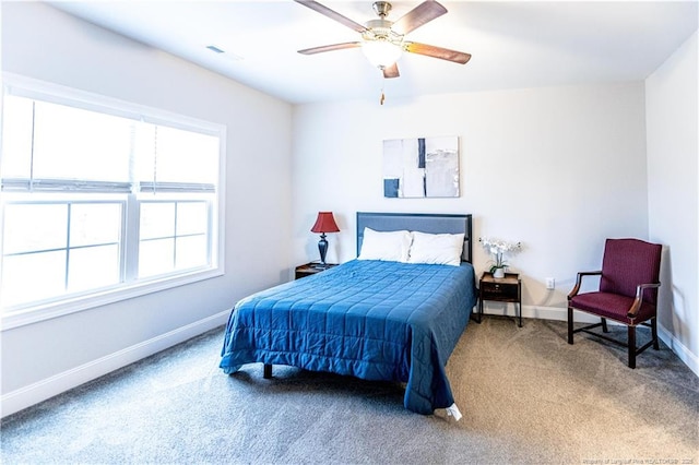 bedroom with baseboards, a ceiling fan, visible vents, and carpet floors