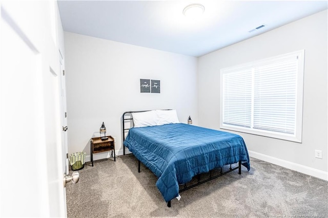 bedroom with visible vents, baseboards, and carpet
