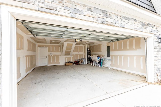 garage with electric panel and a garage door opener
