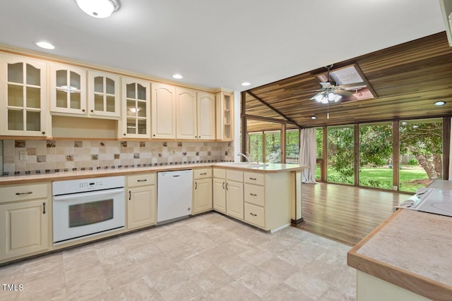 6321 Malvern Ln, Hillsborough, NC 27278 - kitchen with white appliances, a peninsula, ceiling fan, decorative backsplash, and glass insert cabinets