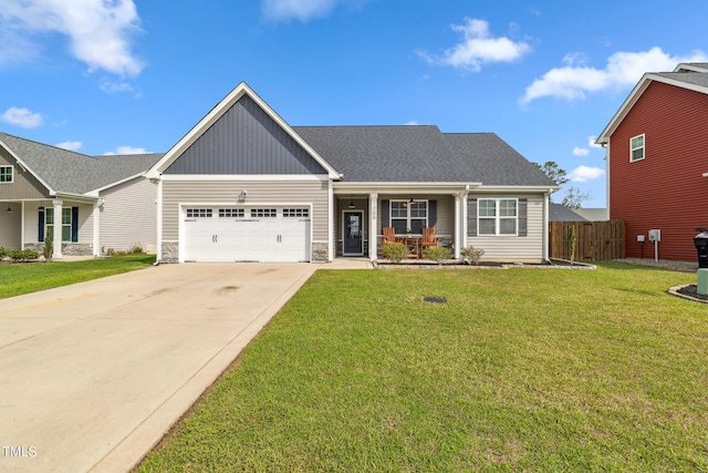 1209 Big Field Dr, Castle Hayne, NC 28429 - view of front of house with a porch, stone siding, a front lawn, a garage, and concrete driveway