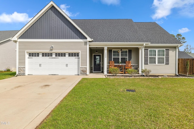 1209 Big Field Dr, Castle Hayne, NC 28429 - craftsman-style home with a porch, an attached garage, fence, concrete driveway, and a front lawn