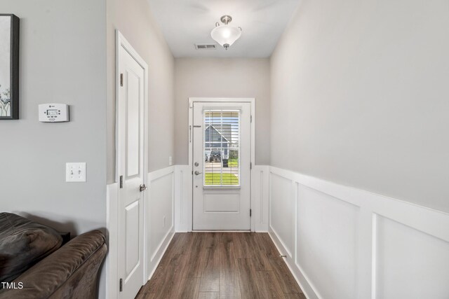 1209 Big Field Dr, Castle Hayne, NC 28429 - doorway to outside featuring visible vents, a wainscoted wall, and dark wood-style floors