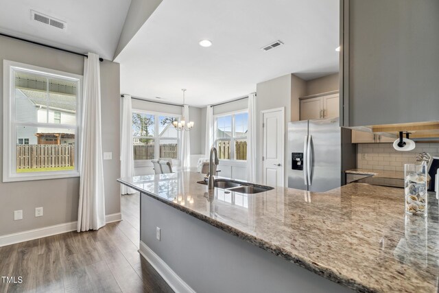 1209 Big Field Dr, Castle Hayne, NC 28429 - kitchen featuring a peninsula, visible vents, stainless steel refrigerator with ice dispenser, a sink, and a notable chandelier