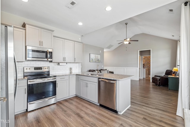 1209 Big Field Dr, Castle Hayne, NC 28429 - kitchen with visible vents, a sink, open floor plan, appliances with stainless steel finishes, and a peninsula