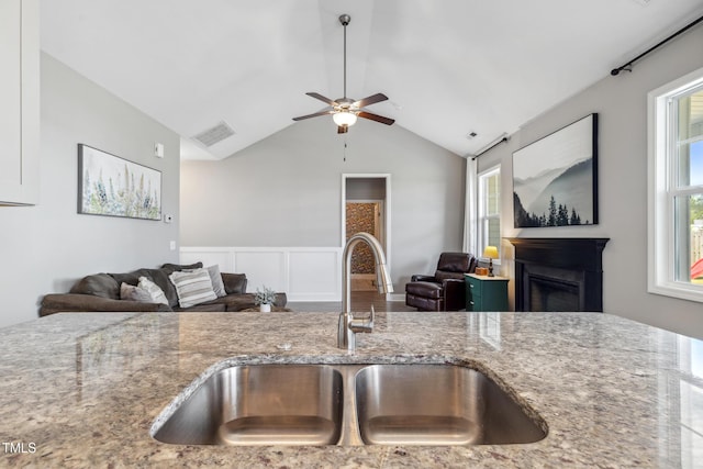 1209 Big Field Dr, Castle Hayne, NC 28429 - kitchen with visible vents, a sink, open floor plan, a healthy amount of sunlight, and light stone countertops